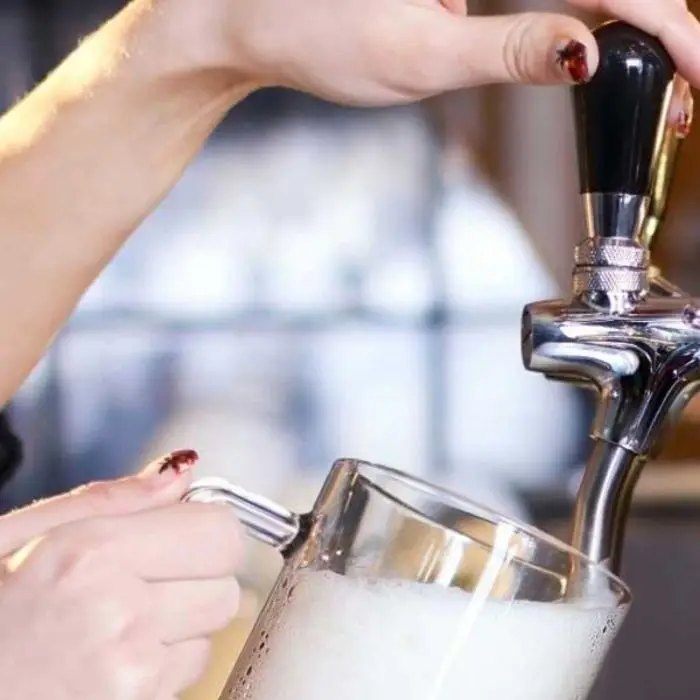 Beer being poured from the tap at a wedding