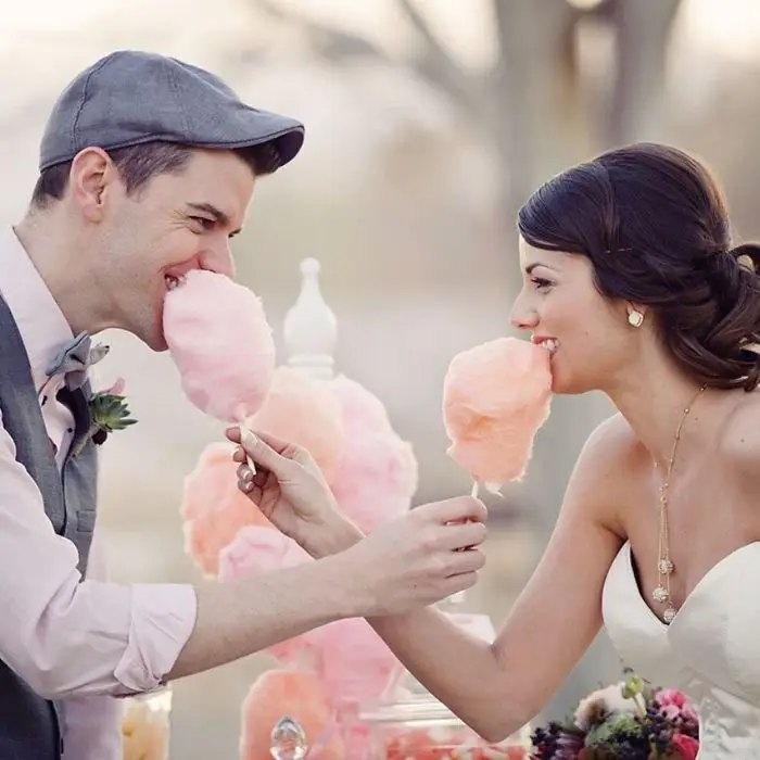 Couple enjoying cotton candy at their wedding