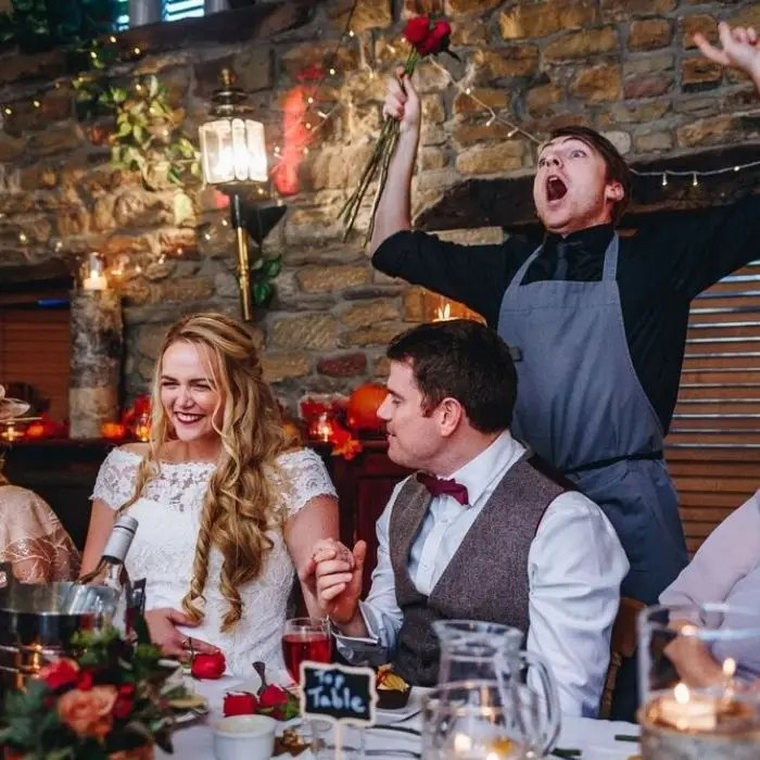 Crazy waiters entertaining guests at the wedding table