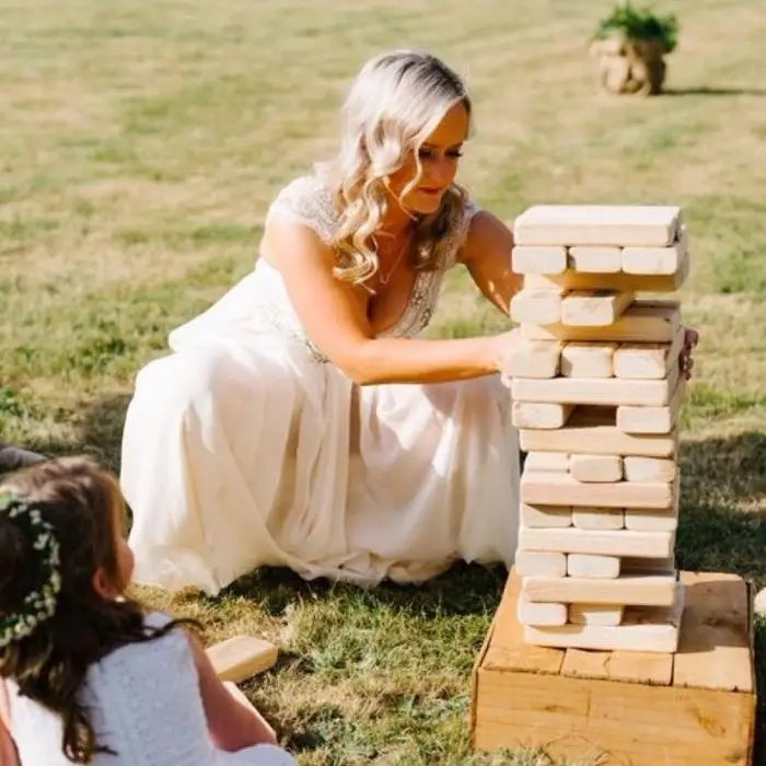 Bride playing giant Jenga at a wedding