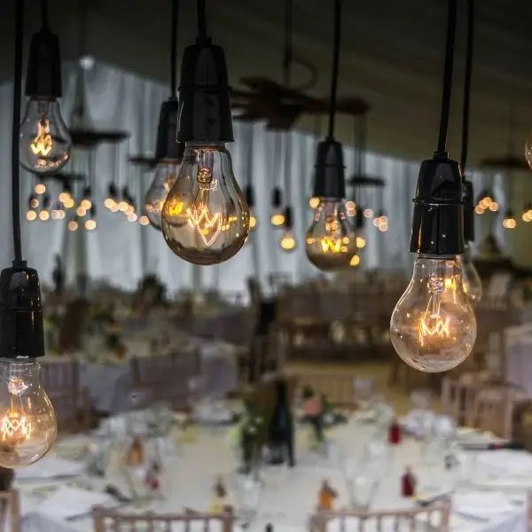 Warm Edison-bulb fairy lights at a wedding