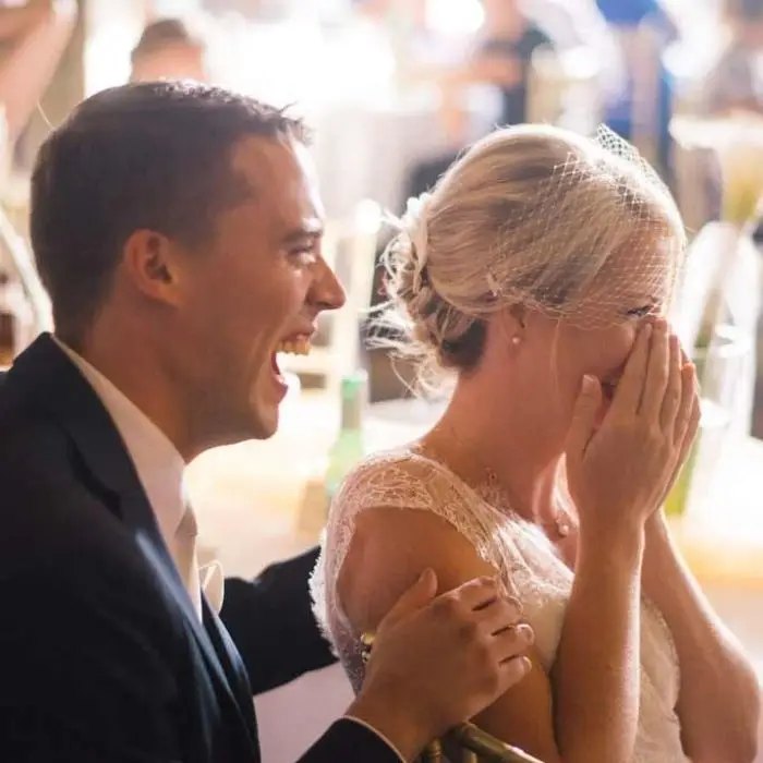 Guests laughing at the wedding quiz show